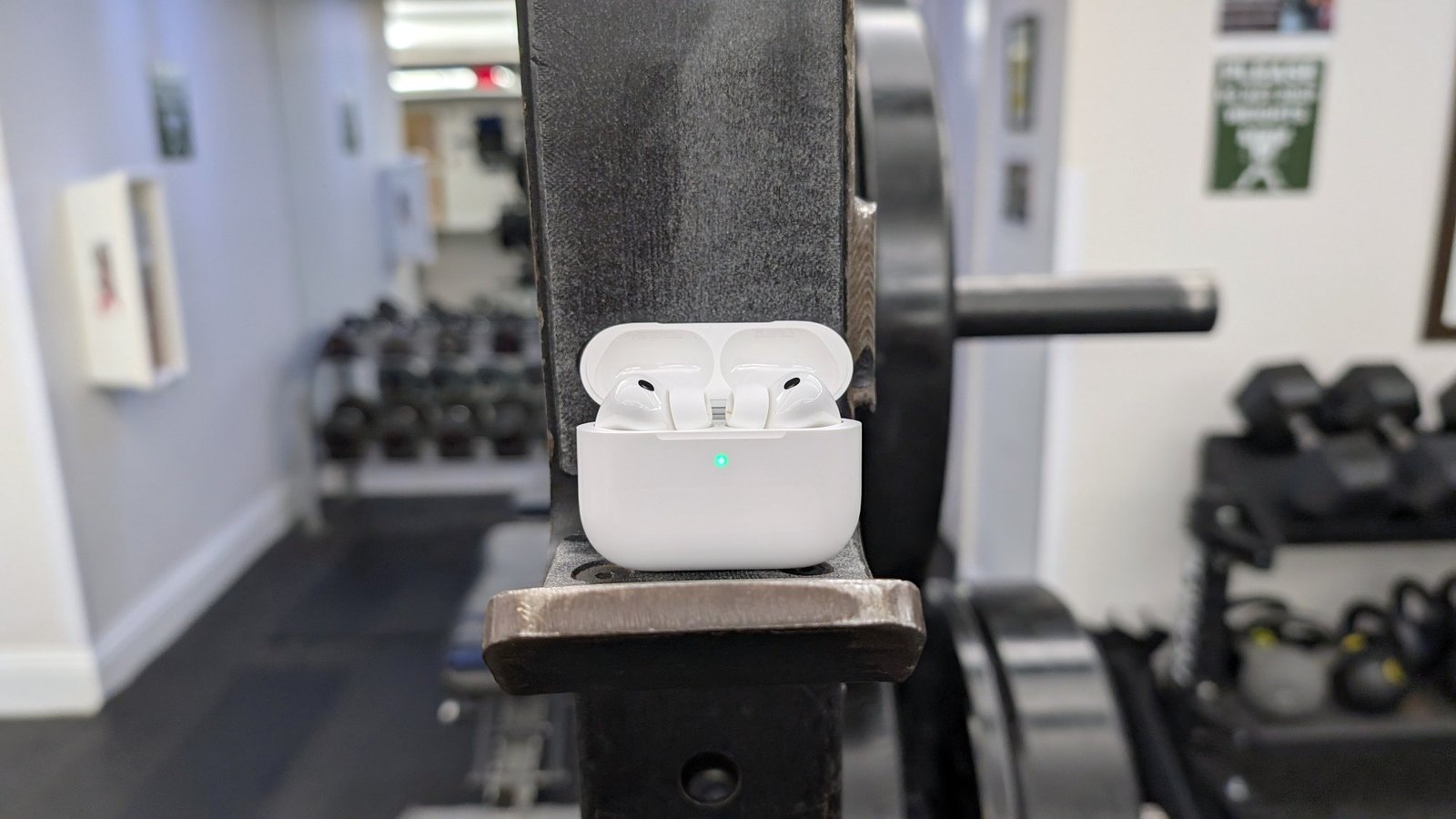 AirPods Pro in their case sitting on some gym equipment